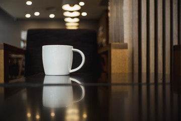 white cup of coffee latte on table in cafe