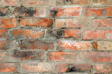 Background of old dirty brick wall with traces of black soot, texture