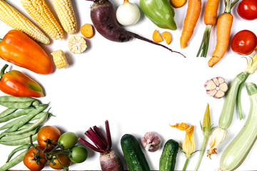 Creative layout made of autumn vegetables. Tomatoes, onion, cucumber, carrot, garlic, red beet,...