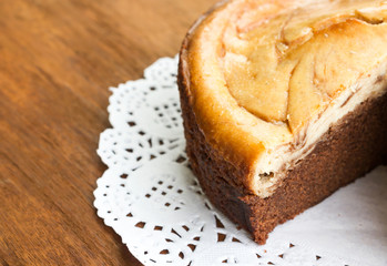 Closeup brownie Cheese Cake on white Doyley Paper. Sweet dessert for chocolate lover.