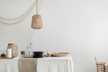 Dining room with wicker lamp, tray and basket - obrazy, fototapety, plakaty