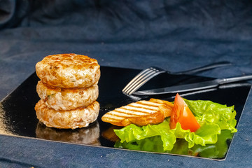 homemade meatballs, cutlets fried from red and white fish meat, in a vintage rustic bowl plate,...