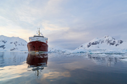 South Atlantic Ocean, Antarctica, Antarctic Peninsula, Gerlache Strait, Paradise Bay, Polar Star icebreaker cruise ship on sea, mountain in background