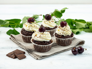 Chocolate Cupcakes with Cherry and White Cream