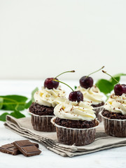 Chocolate Cupcakes with Cherry and White Cream