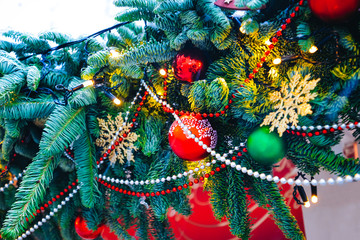 Christmas tree branches with decor, garlands, lights