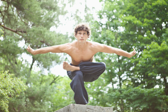 Germany, Bavaria, Young man performing martial arts