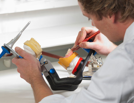 Dentist preparing dentures in dental laboratory