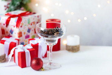 New Year and Christmas concept. Toys, gifts, tree, glass with cones, garland