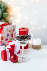 New Year and Christmas concept. Toys, gifts, tree, glass with cones, garland