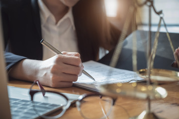law concept, lawyer woman hoding pen with contract or agreement document to customer for signing in...