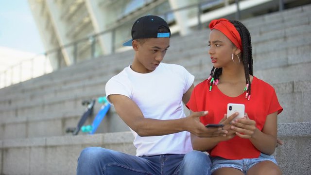 Mixed-race guy jealous of girlfriend chatting in social networks with other boys