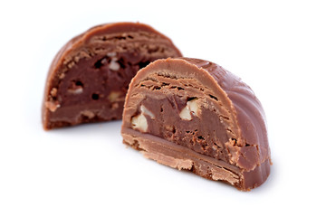 Broken chocolate candy, white background, top view