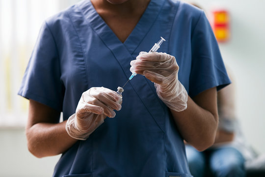 Exam: Nurse Fills Syringe With Vaccine