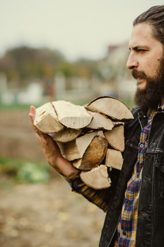 man carries wood pieces