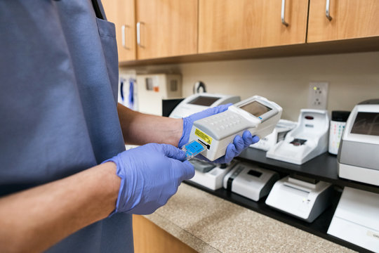 Clinic: Male Tech Running Blood Tests On Patient Sample