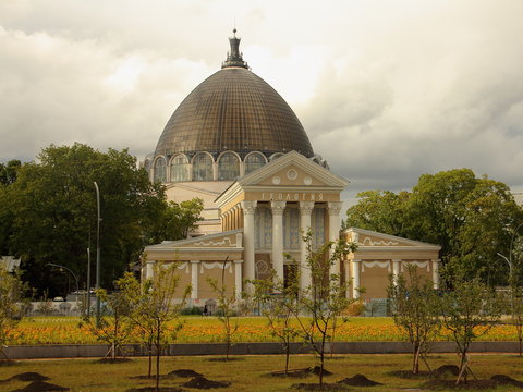 Moscow, Russia, Geology pavilion at VDNH on the background of the dome of the Kosmos pavilion at VVC on summer day
