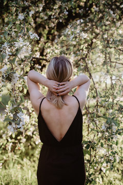 Woman in dress under blooming tree