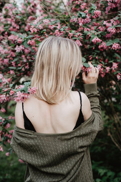 Woman in dress under blooming tree