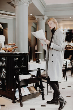 Woman reading newspaper in cozy reception