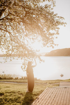 Woman in dress under blooming tree