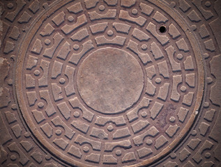 Fototapeta na wymiar sewer metal iron hatch on the sidewalk with vignette. background, texture.
