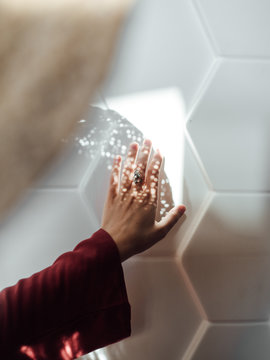 Crop hand touching specks of light