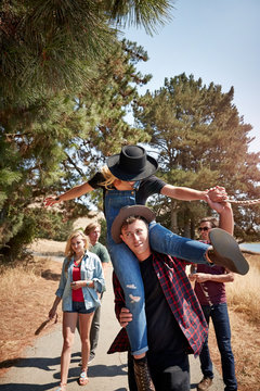 Group of friends walking on pathway having fun