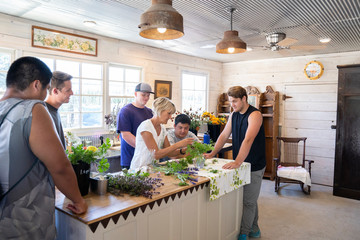College football players volunteering to help at a flower farm