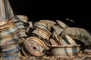 pile of old discarded tire rims