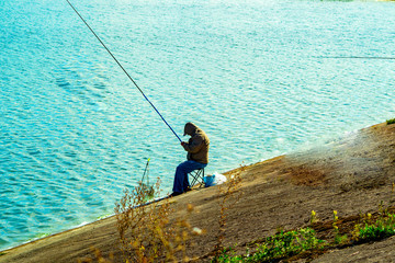 angler with fishing rod on the lake