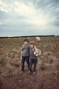 Two little brothers in a field