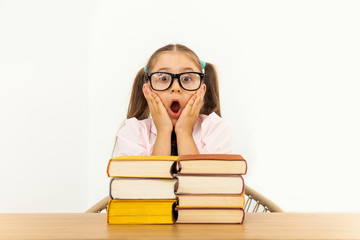 Girl studying at table on white background