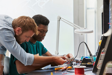 Teacher Assisting Student In Technical Project