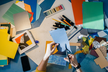 Woman in a studio office working with paper collage
