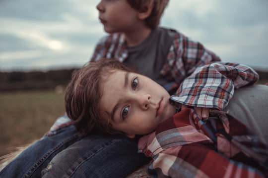 Portrait of a little boy on a haystack