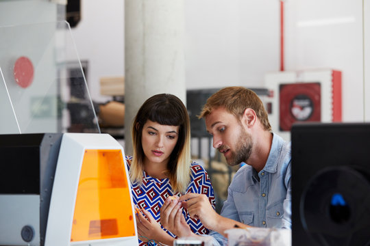 Teacher Assisting Student In Printing 3D Design
