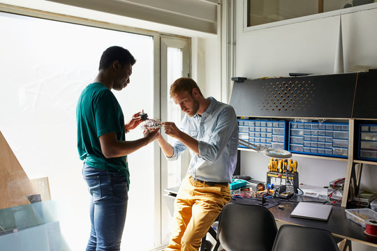Teacher Examining Technical Project Of Student