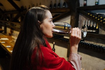 Woman tasting red wine