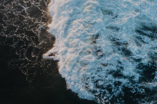 Top view. man on a surfboard is riding a wave. shooting from above
