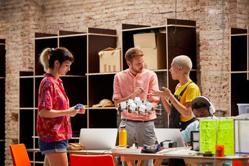 Teacher Guiding Students During Project At Table