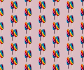 Rainbow lolly candy on a taupe background