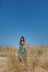 Free happy woman enjoying sun on vacations in dunes..Concept of happiness, enjoyment and well being. Sea, sand and sun.