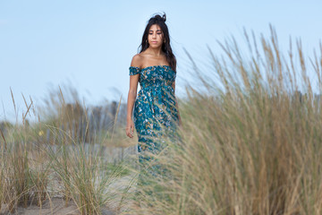 Obraz premium Free happy woman enjoying sun on vacations in dunes..Concept of happiness, enjoyment and well being. Sea, sand and sun.