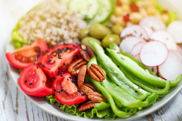 Hummus platter with assorted snacks. Hummus in bowl, vegetables sticks, chickpeas, olives. Plate with Middle Eastern/Mediterranean meze. Party/finger food. Top view. Vegetables, hummus dip,copy space