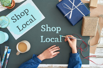 Overhead of artist painting shop local sign