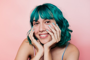 Smiling teenager with turquoise hair