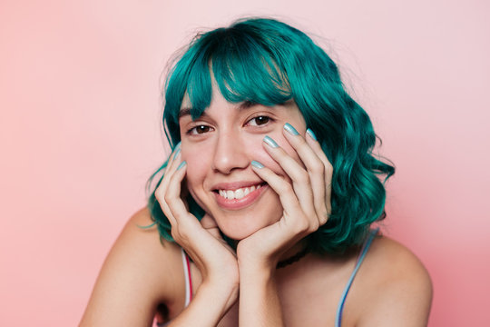 Smiling teenager with turquoise hair