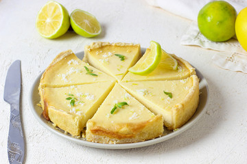 key lime pie on white background with limes