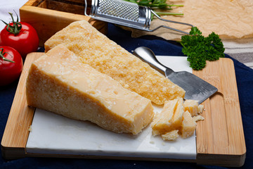Italian original aged Parmesan cheese in two pieces close up